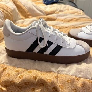 This is a pair of Adidas VL Court 3.0 sneakers in a white black and gum colorway